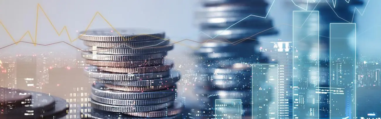 Stacks of coins against a city skyline overlaid with market chart lines
