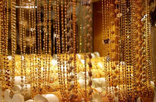 Gold chains and necklaces on display in a jeweller's window